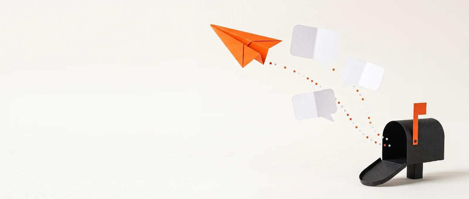 Un avión de papel naranja y burbujas de diálogo blancas salen volando de un pequeño buzón negro.